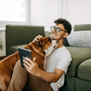 Man with dog looking at tablet